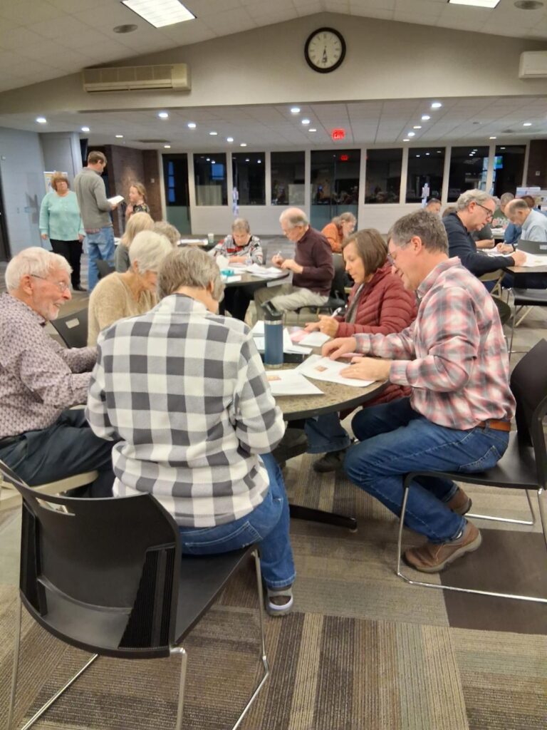 Volunteers writing cards around a table