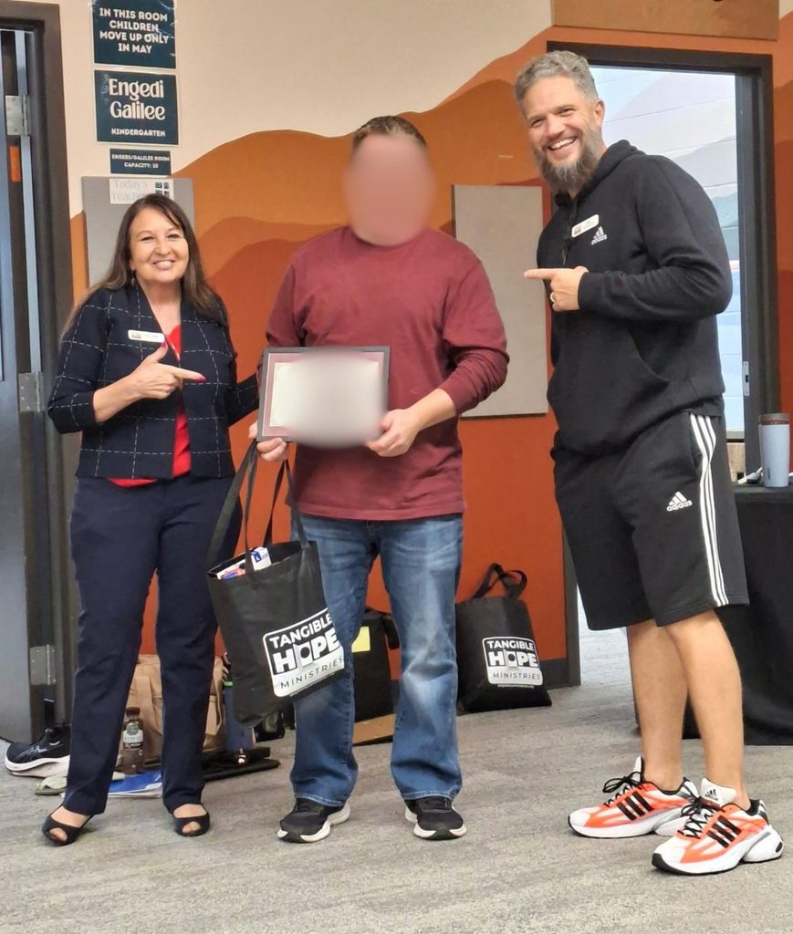Paula and Troy with a Living Forward Reentry Graduate (face blurred)